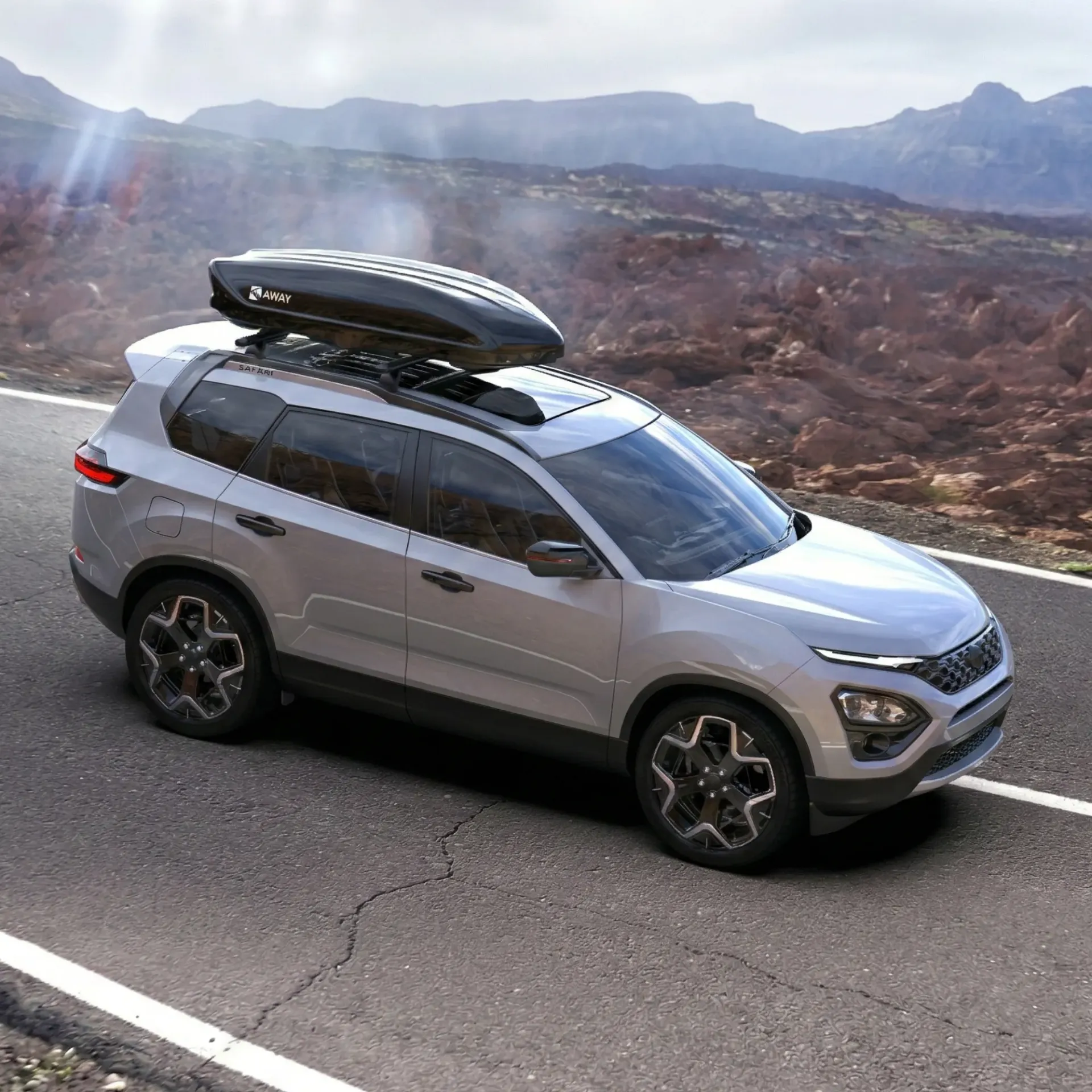 Car with rooftop cargo box on scenic road